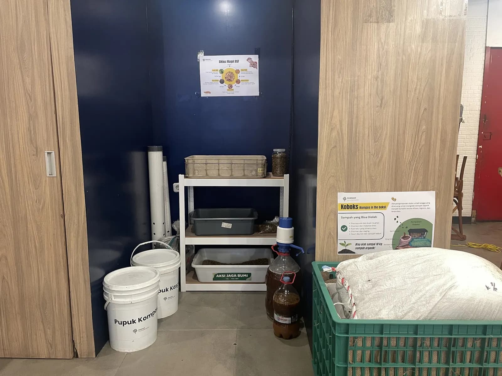 Sudut penampungan di Jagabumi Ecomart dengan ember, jeriken, rak, dan krat hijau